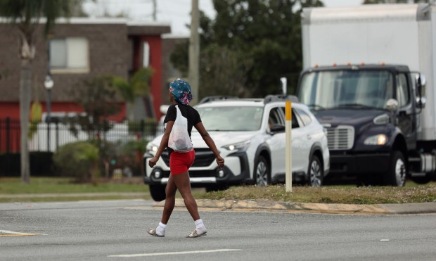 A pedestrian crosses State Road 436 in Casselberry, on Tuesday, January 13, 2026. (Ricardo Ramirez Buxeda/Orlando Sentinel)