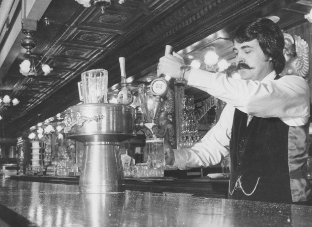 Rosie O'Grady's owner Bob Snow draws a beer in 1975, happier days for the Goodtime Emporium at Church Street Station. (Orlando Sentinel file)