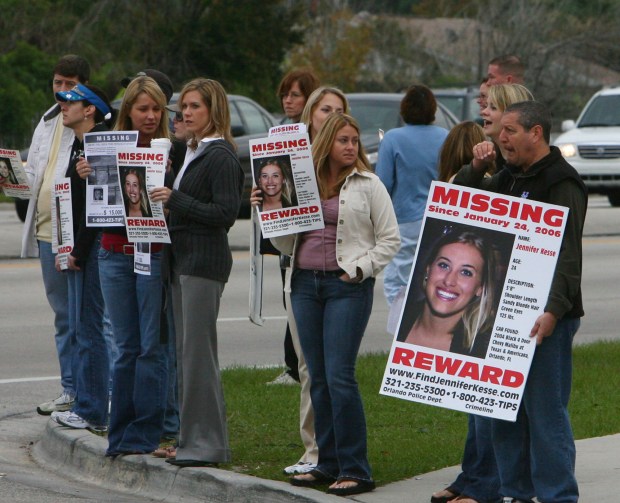 People gather holding missing persons signs January 24, 2007 of Jennifer Kesse at the corner of John Young Parkway and Conroy Rd. It's been a year since the disappearance of Jennifer Kesse. (Red Huber/Orlando Sentinel)