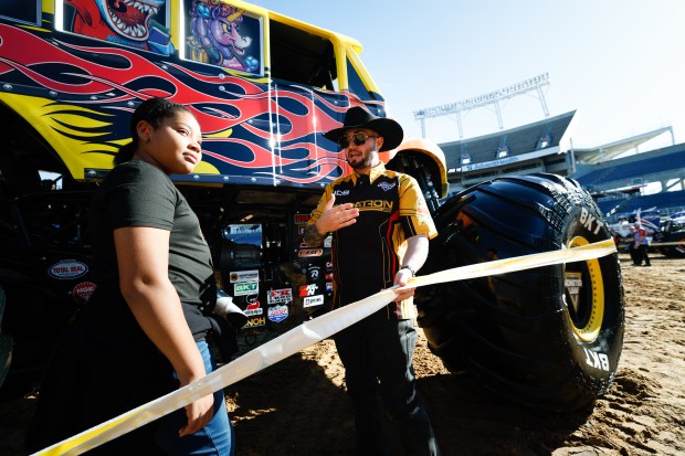 JCB Digatron driver Tristan England tells Jeayda Gardner about the Classroom Crusher truck. Gardner was surprised by the smoothness and had expected a monster truck to be "really rough." Taken during the Blind Touch-A-Truck event for kids and teenagers from Lighthouse Central Florida on Friday, January 9, 2025. (Rich Pope/Orlando Sentinel)