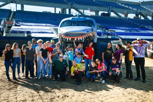 The group gathers for a picture together under the menacing grill of the Megalodon truck. Taken during the Blind Touch-A-Truck event for kids and teenagers from Lighthouse Central Florida on Friday, January 9, 2025. (Rich Pope/Orlando Sentinel)