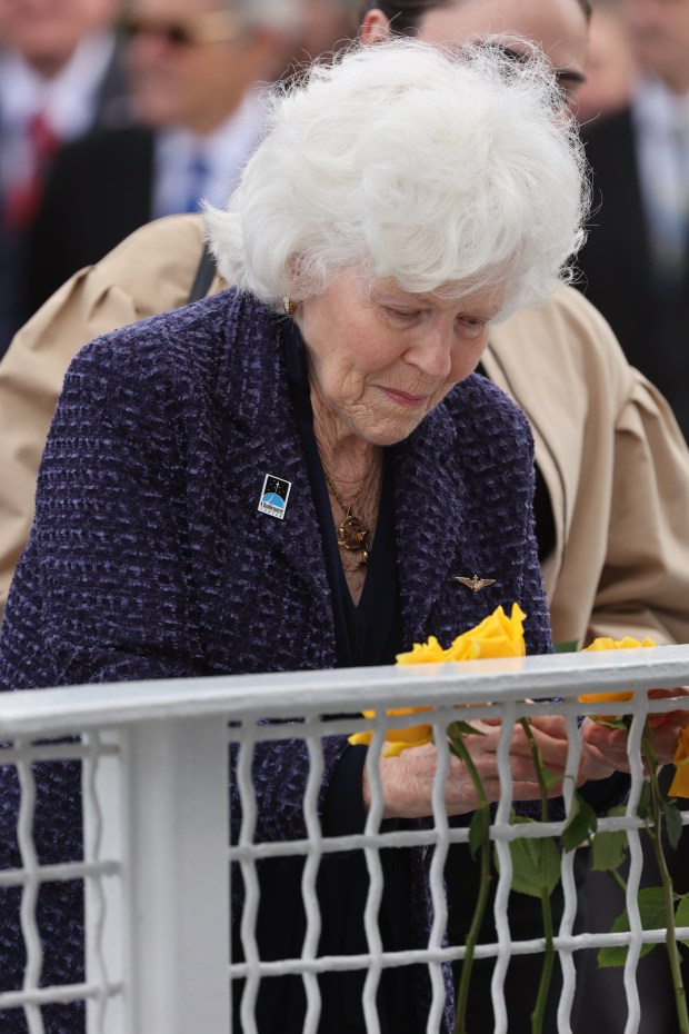 Jane Smith Wollcott, widow of Challenger pilot Michael J. Smith, places a flower at the Space Mirror Memorial during NASA's Day of Remembrance ceremony at the Kennedy Space Center Visitor Complex, on Thursday, January 22, 2026. (Ricardo Ramirez Buxeda/ Orlando Sentinel)