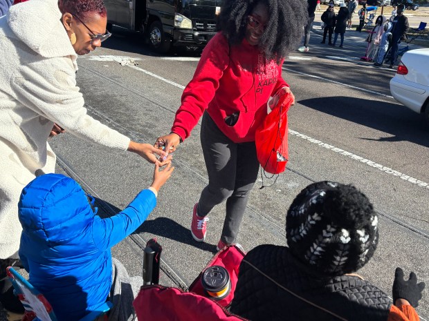 A young spectator takes a handful of candy during Ocoee's 18th Annual Dr. Martin Luther King, Jr., Unity Parade on Monday, January 19, 2026. (Rich Pope/Orlando Sentinel)