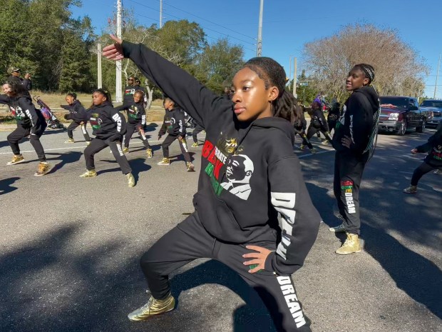 Members from the Standing Ovation Talent Group perform during Ocoee's 18th Annual Dr. Martin Luther King Jr. Unity Parade on Monday, January 19, 2026, as community officials, charities, clubs, and youth organizations from Orange County and the surrounding neighborhoods bundled up for a cold morning parade to celebrate the legacy of America's famous civil rights leader. (Rich Pope/Orlando Sentinel)