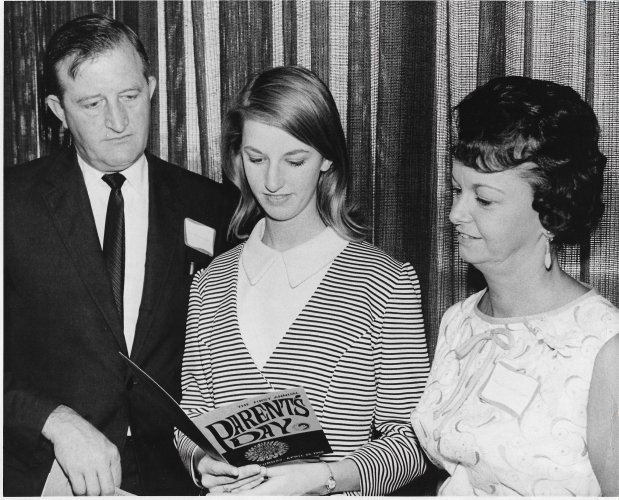 Mr. and Mrs. Bernard C. Scott of Winter Park, with daughter Charlott, look at the FTU Parents Day schedule on April 26, 1969. (Sentinel file)