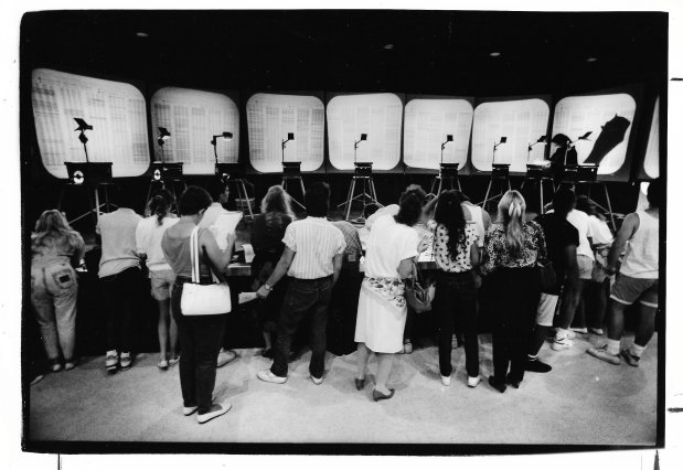 This is how class registration worked at UCF in the 1980s. Classes were displayed by overhead projector and students wrote down their choices to be entered into a computer. As classes filled, they were crossed off on the displays. From Aug. 18, 1988. (Sentinel file)