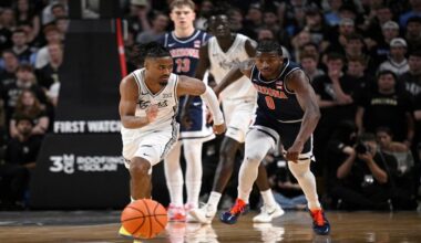 UCF guard Themus Fulks, left, chases down a loose ball against Arizona guard Jaden Bradley (0) during the first half of an NCAA college basketball game, Saturday, Jan. 17, 2026, in Orlando, Fla. (AP Photo/Phelan M. Ebenhack)