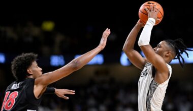 UCF guard Themus Fulks goes up to shoot the game-winning shot as Cincinnati forward Baba Miller (18) defends on Sunday, Jan. 11, 2026, in Orlando, Fla. (AP Photo/Phelan M. Ebenhack)