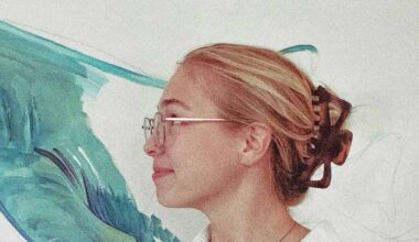 Fifth-year FGCU student Macy Noll installing 'Knowledge in Motion' mural in Wilson G. Bradshaw Library