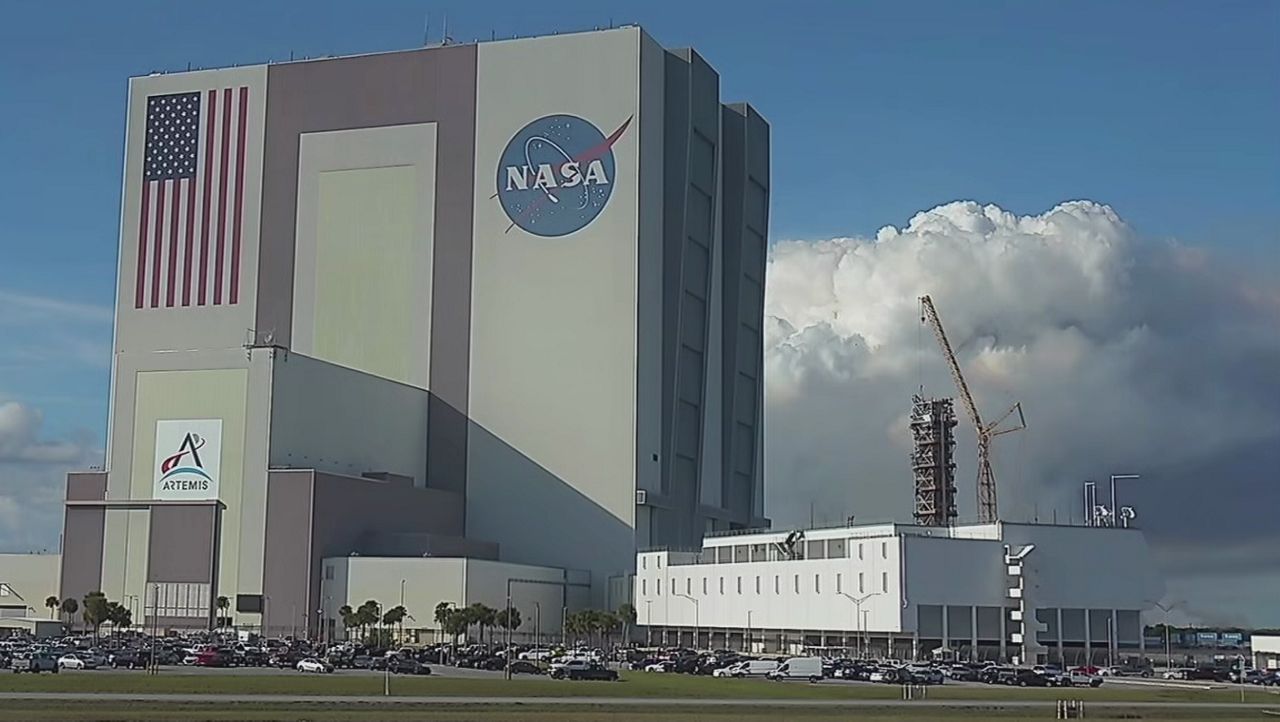 Smoke plumes from a controlled burn on Merritt Island can be seen behind Kennedy Space Center's Vehicle Assembly Building on Jan. 9, 2026. (Spectrum News)