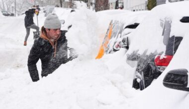 Residents dig out their cars in the South Boston neighborhood following a winter storm that dump more than a foot of snow across the region, Monday, Jan. 26, 2026, in Boston. (AP Photo/Charles Krupa)