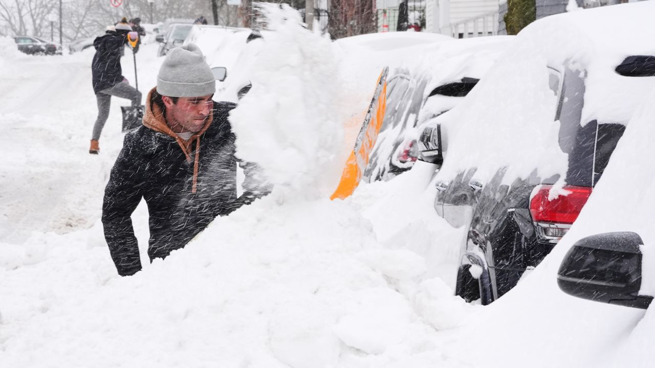 Residents dig out their cars in the South Boston neighborhood following a winter storm that dump more than a foot of snow across the region, Monday, Jan. 26, 2026, in Boston. (AP Photo/Charles Krupa)