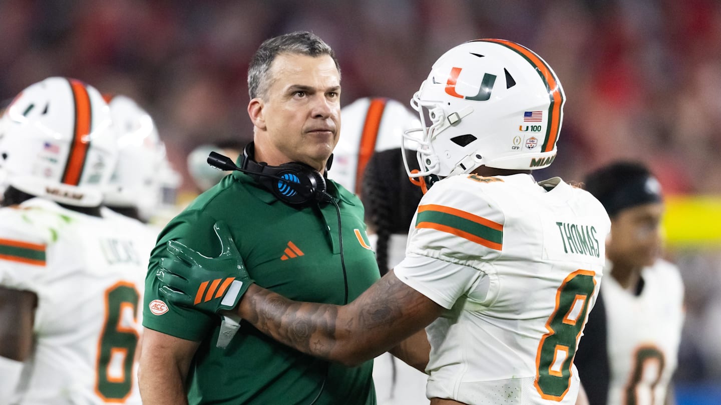 Jan 8, 2026; Glendale, AZ, USA; Miami Hurricanes head coach Mario Cristobal with defensive back Jakobe Thomas (8) against the Mississippi Rebels during the 2026 Fiesta Bowl and semifinal game of the College Football Playoff at State Farm Stadium. Mandatory Credit: Mark J. Rebilas-Imagn Images