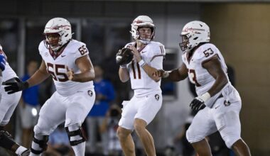 Sep 28, 2024; Dallas, Texas, USA; Florida State Seminoles quarterback Brock Glenn (11) drops back to pass between offensive lineman Andre Otto (65) and offensive lineman Maurice Smith (53) during the second half at Gerald J. Ford Stadium. Mandatory Credit: Jerome Miron-Imagn Images
