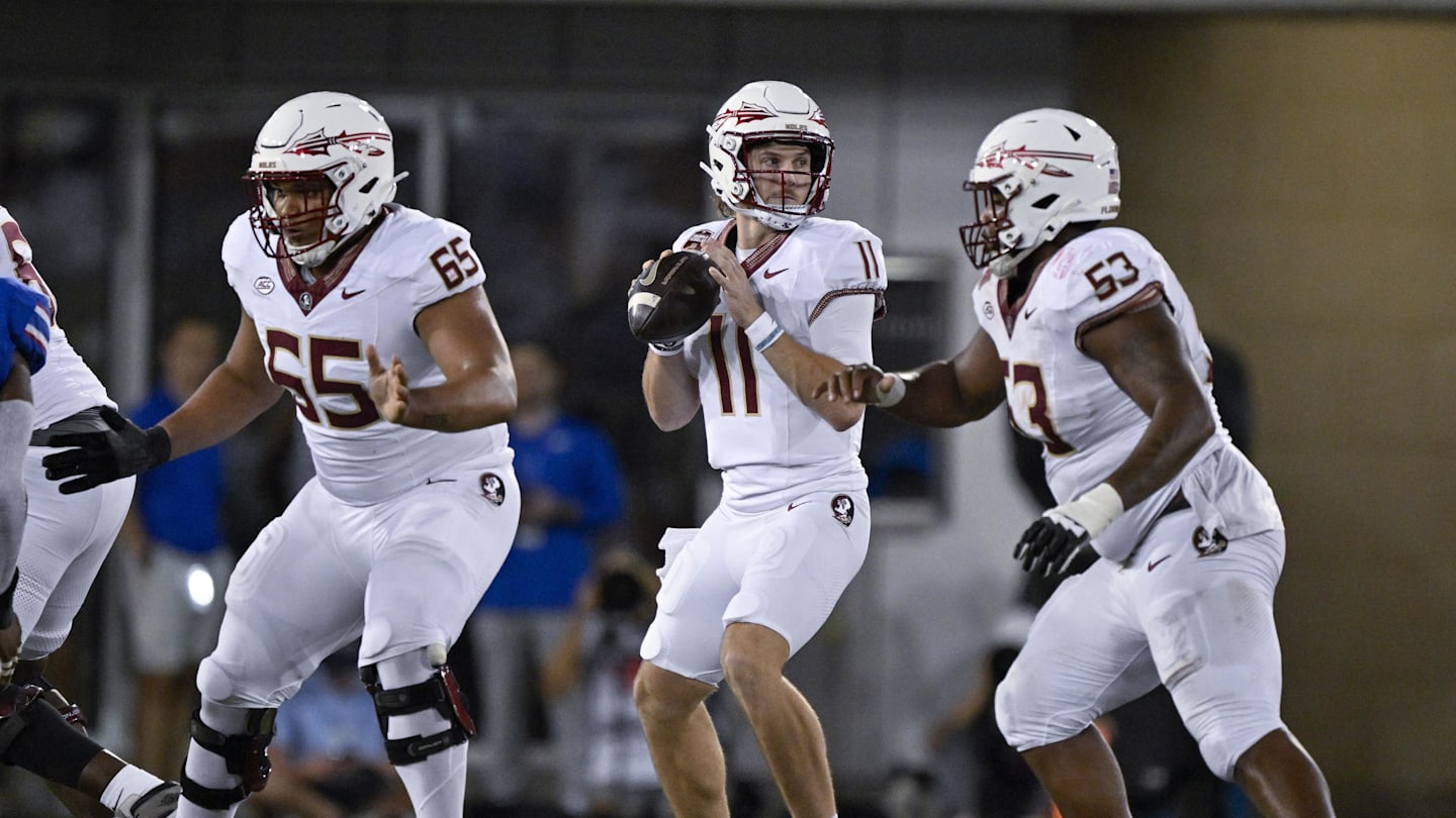 Sep 28, 2024; Dallas, Texas, USA; Florida State Seminoles quarterback Brock Glenn (11) drops back to pass between offensive lineman Andre Otto (65) and offensive lineman Maurice Smith (53) during the second half at Gerald J. Ford Stadium. Mandatory Credit: Jerome Miron-Imagn Images