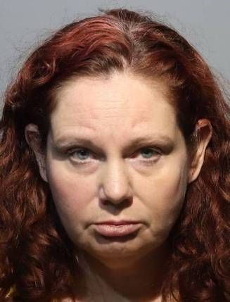 Mugshot of Mackenzie Lane McLean, a 49-year-old woman with red hair and light eyes.