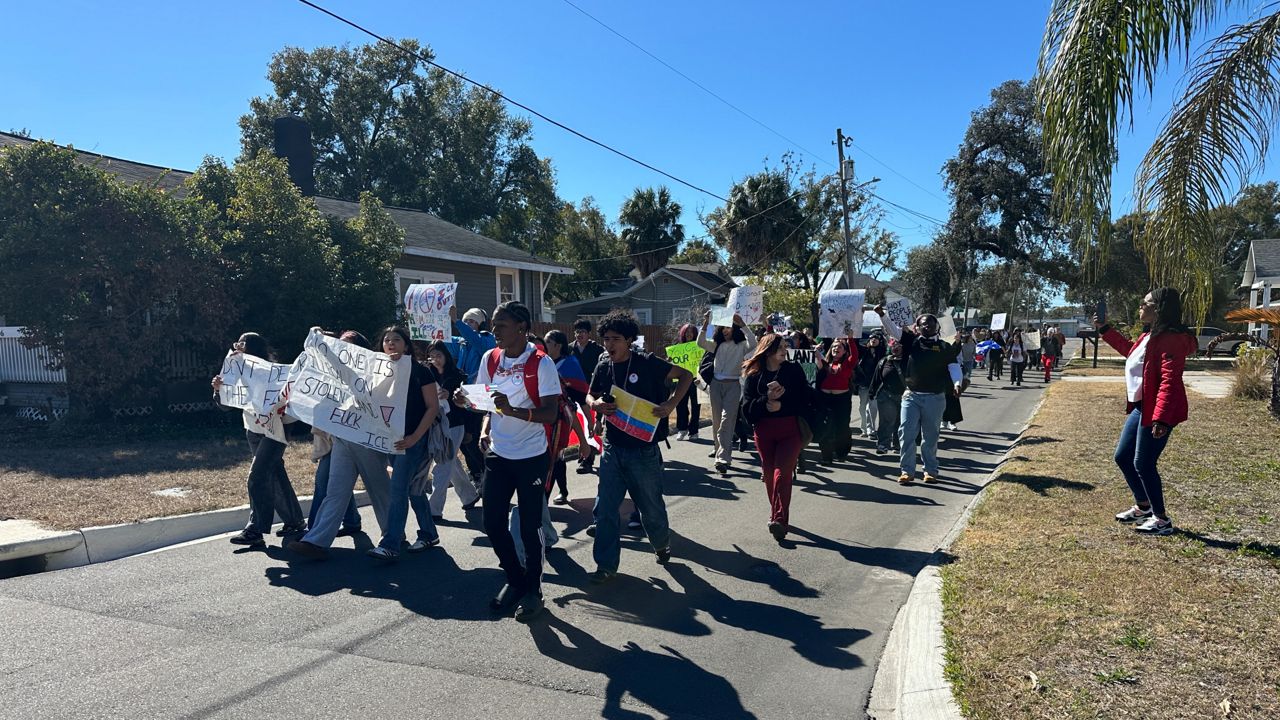 About 60 students walked out of the school and gathered around the flag pole to protest ICE. (Spectrum News/Fallon Silcox)