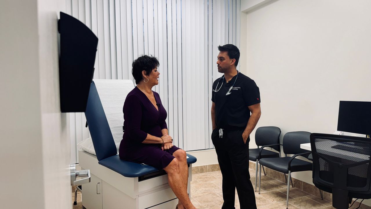 Dr. Jesal Popat, an Interventional Cardiologist with Orlando Health, talks with patient Maureen Cravey. (Spectrum News/Erin Murray)