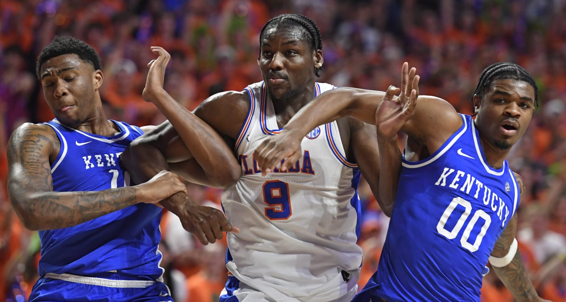 Florida center Rueben Chinyelu (9) is boxed out by Kentucky guard Otega Oweh (0) and forward Brandon Garrison (10) as the Florida Gators face the Kentucky Wildcats at the Stephen C. O’Connell Center on Saturday, Feb. 14, 2026, in Gainesville, Fla.