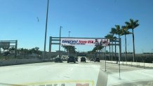 A sign reading "Welcome Home - Congrats! Team USA Olympic Gold Medal" outside Miami International Airport on Feb. 23, 2026.