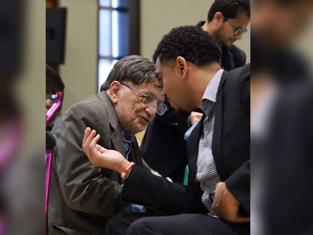 “Richard Aló, Ph.D., shares a moment with event MC Adam Ramgeet during the AI & Data Science Workshop.