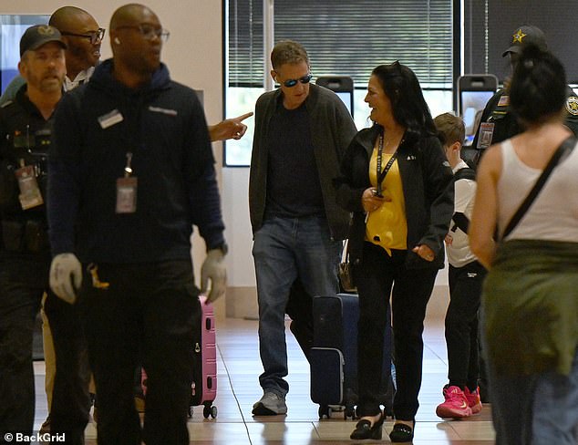 Feldman wore sunglasses and was escorted by security upon arrival in Florida