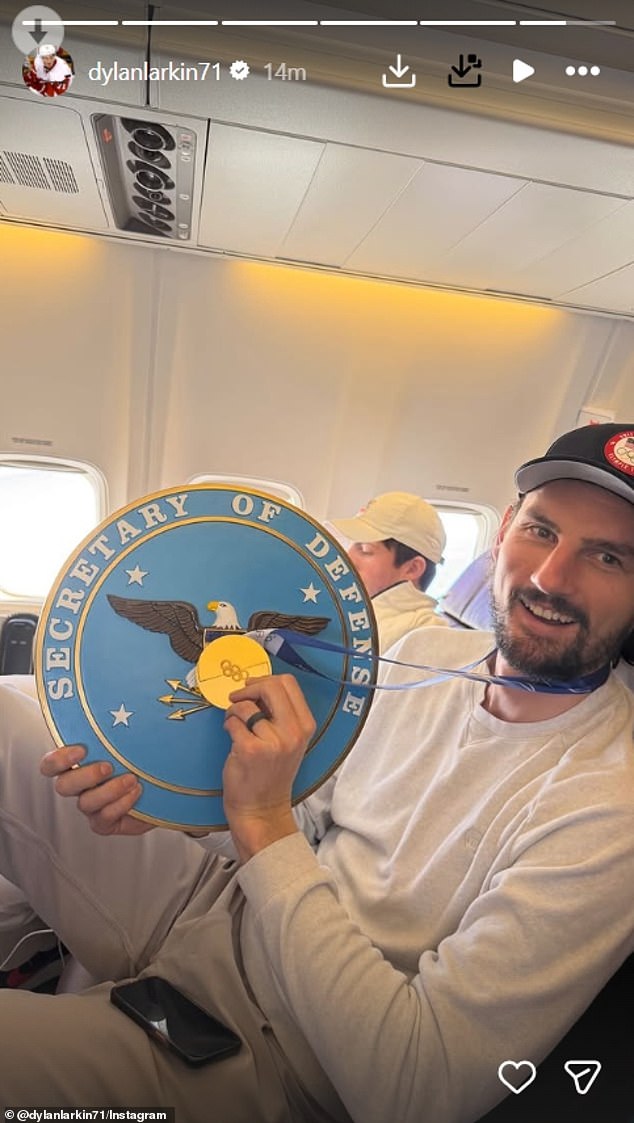 Team USA goalie Connor Hellebuyck is pictured by teammate Dylan Larkin aboard the 757