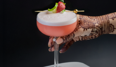 a hand with henna and a cocktail