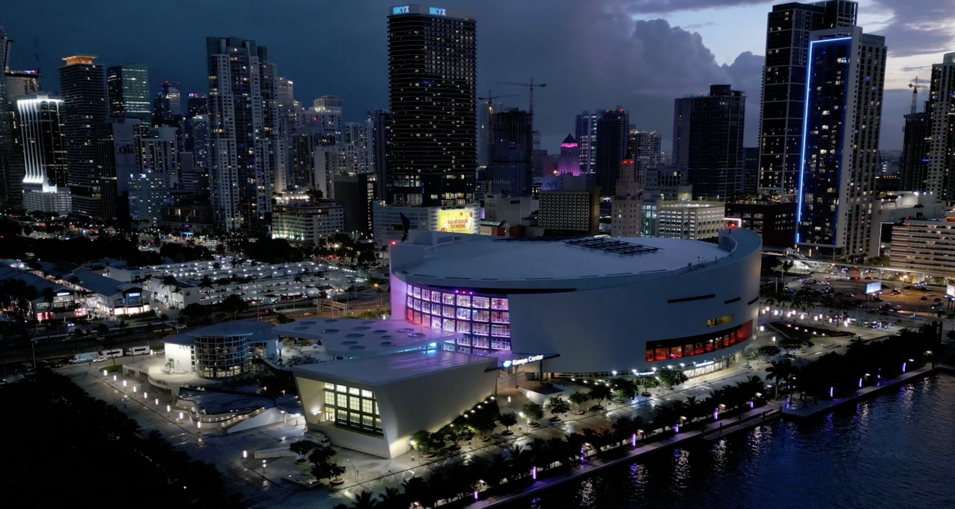 aerial view of Miami's Kaseya Center arena with the city skyline behind it