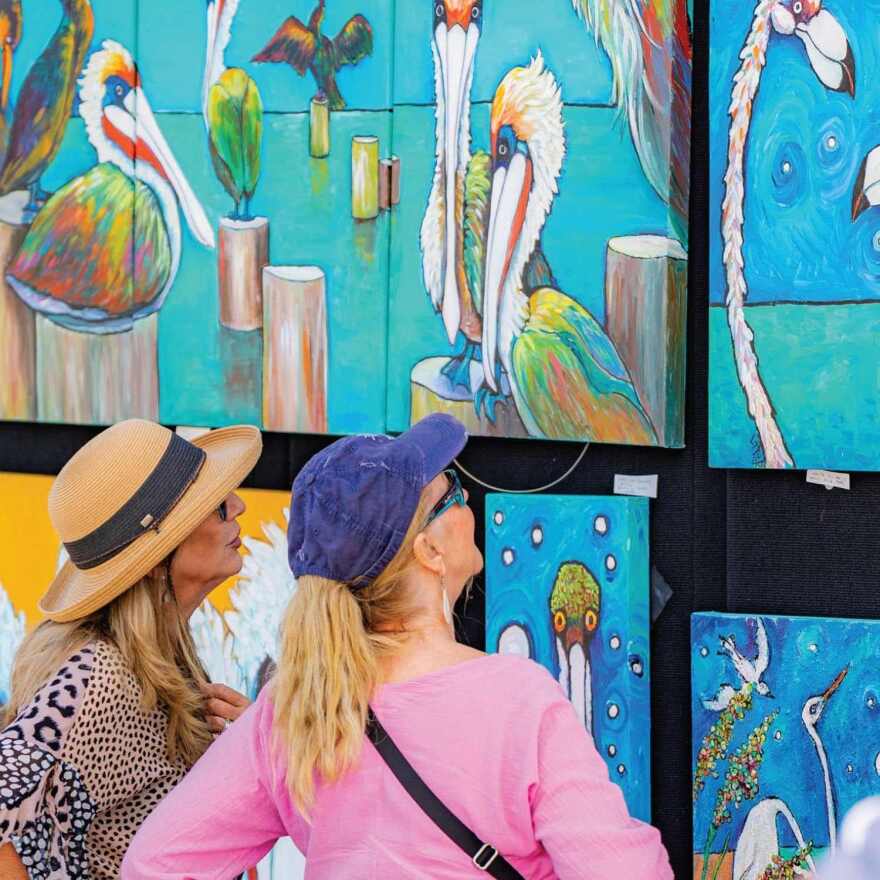 Visitors look at art at art festival