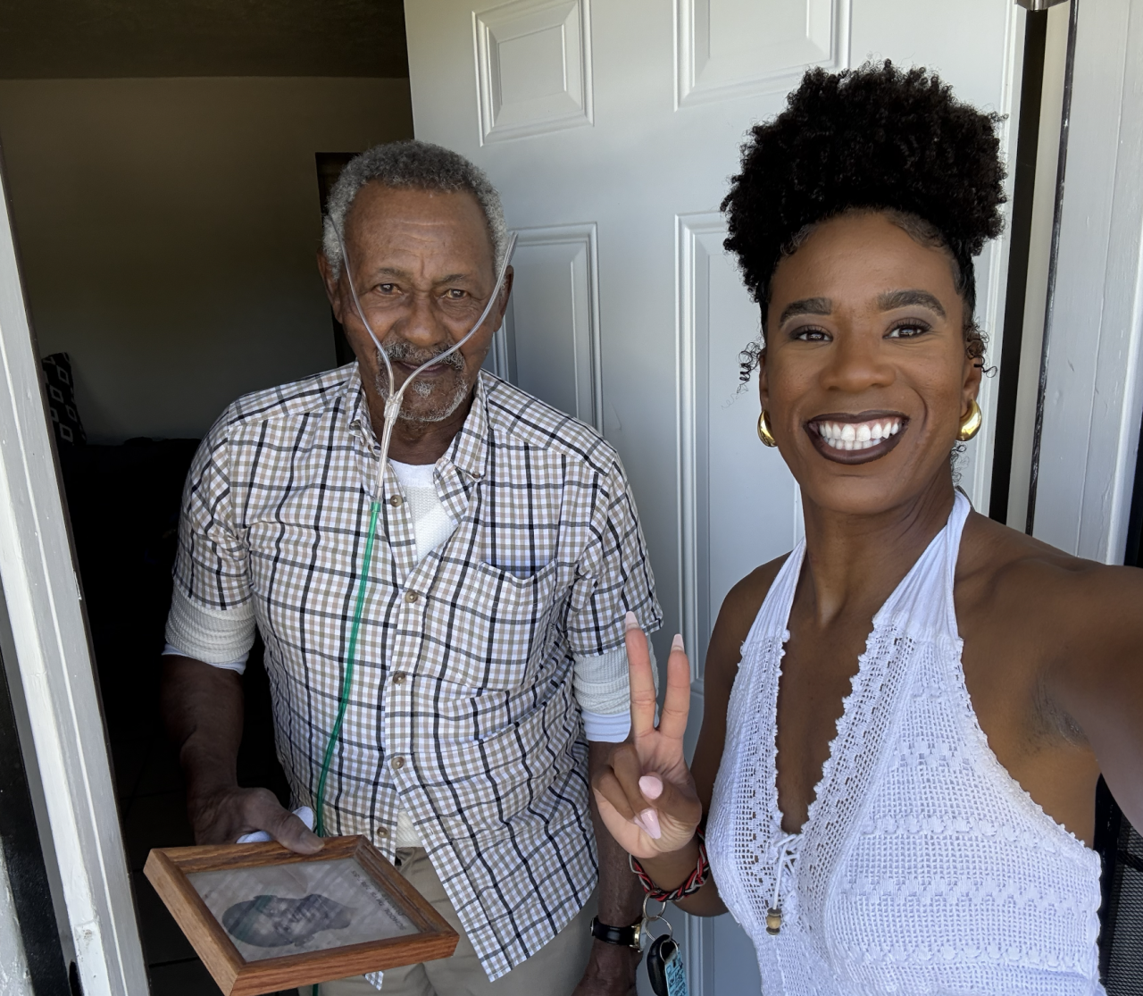 H. "Yunk" Frederick holding his Dunbar High School Photo
