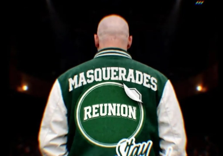 ear view of Tampa artist DJ Fader wearing a green and white Masquerades Reunion varsity letterman jacket on stage.