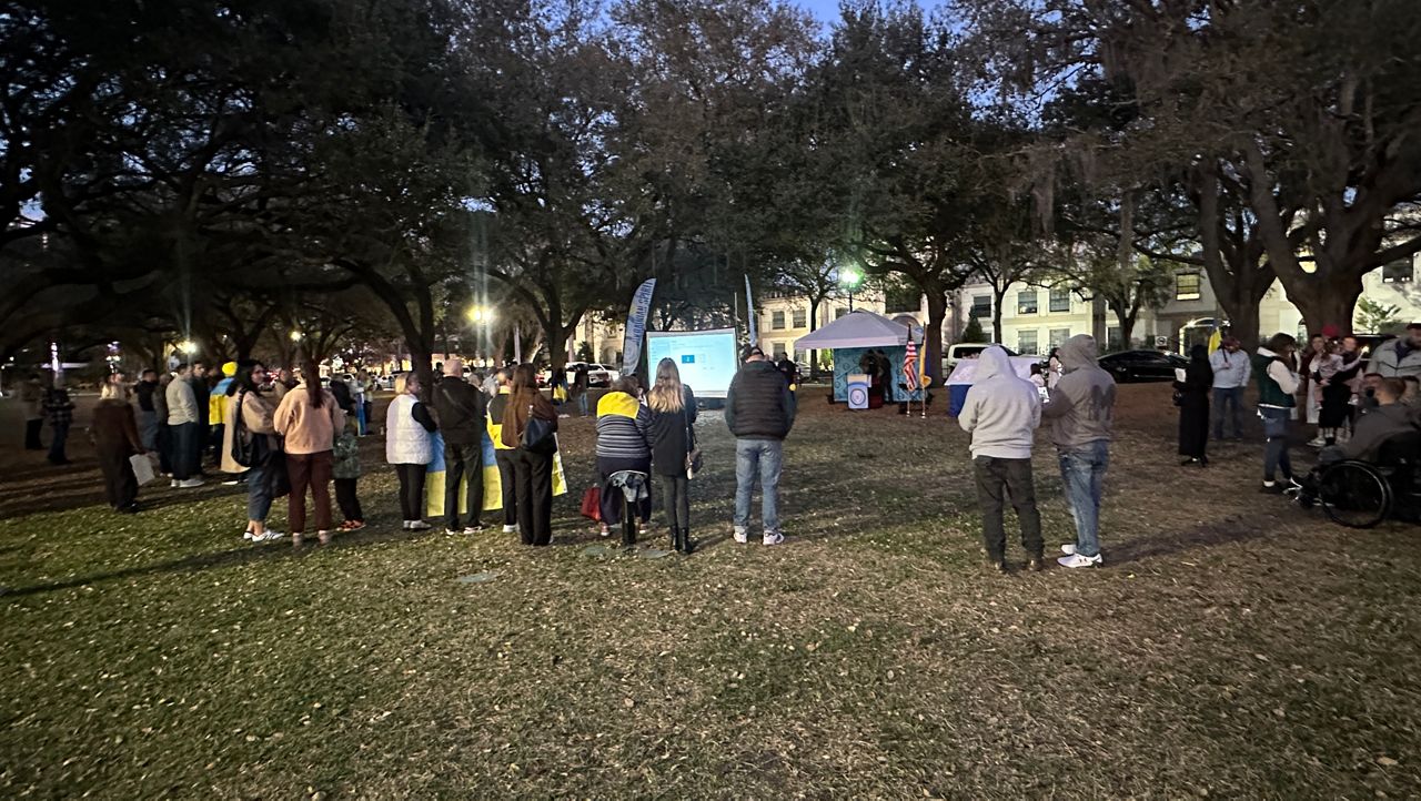 Nearly 100 people gather at Lake Eola Park in downtown Orlando Tuesday to mark the anniversary of the start of the war between Ukraine and Russia. (Spectrum News/Brandon Spencer)