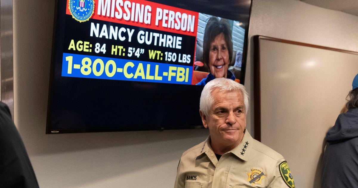 Pima County Sheriff Chris Nanos exits the press room past a missing person poster after giving an update on the investigation into the disappearance of Nancy Guthrie in Tucson, Arizona, Feb. 5, 2026.