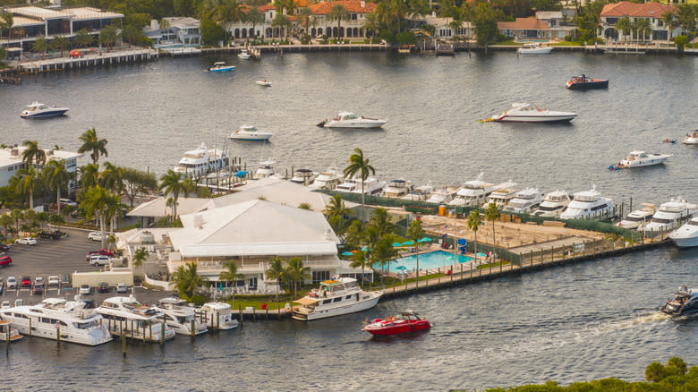 Coral Ridge Yacht Club with luxury yachts in the water.