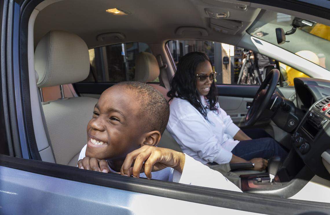 Kingston Allen, 4, and his mom, Renee King, 36, inspect the refurbished Subaru Impreza they were gifted at a Midas on Thursday, Feb. 12, 2026, in Fort Lauderdale. King, a single mom with two children, relied entirely on public transportation to get to work from Broward to Miami. 