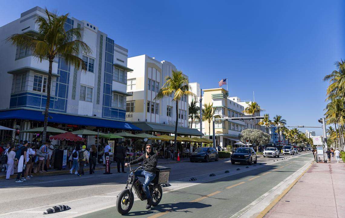 A man makes his way down Ocean Drive near Lummus Park on Tuesday, Feb. 24, 2026, in Miami Beach, Florida.