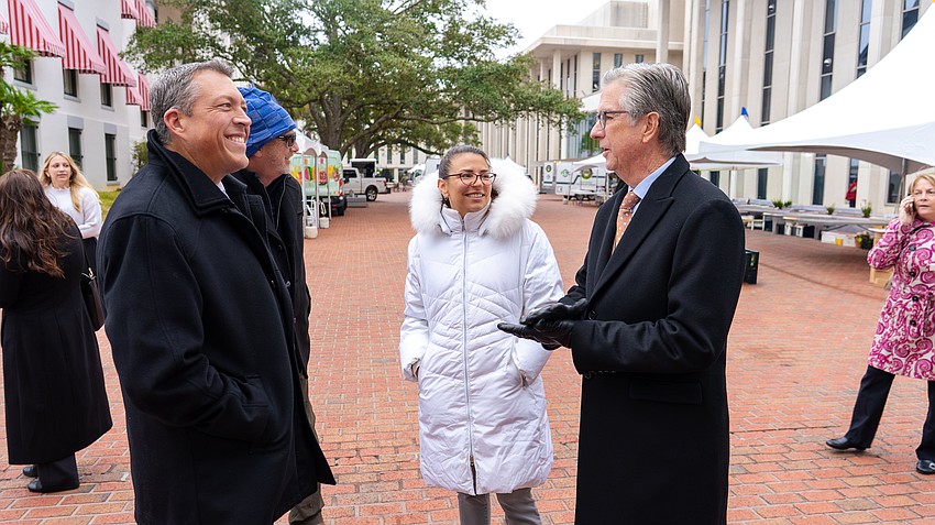 Commissioner George Kruse, County Administrator Charlie Bishop and Commissioner Amanda Ballard speak with Senator Jim Boyd during Manatee County Day.