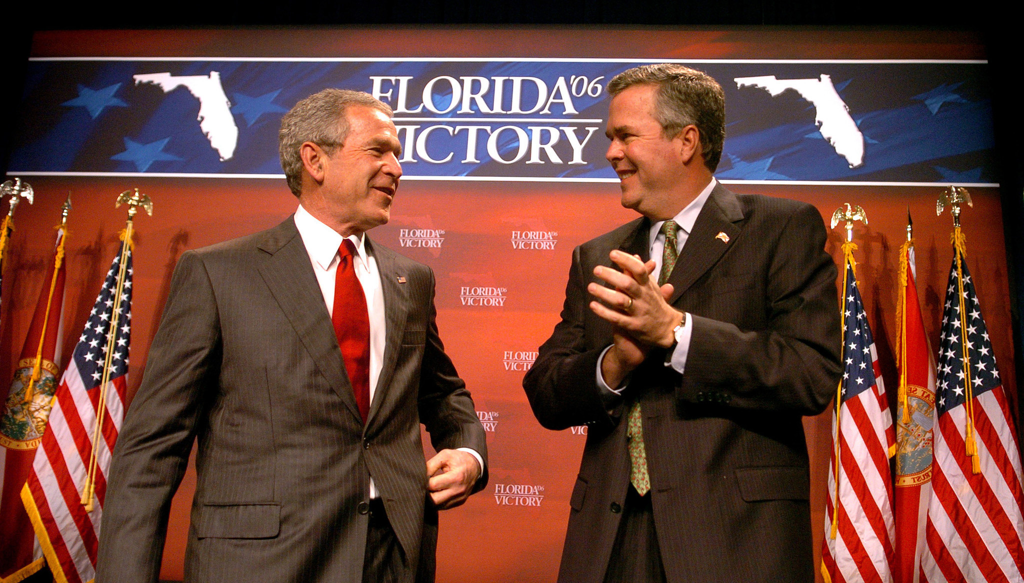 President George Bush chats with brother Gov. Jeb Bush as...