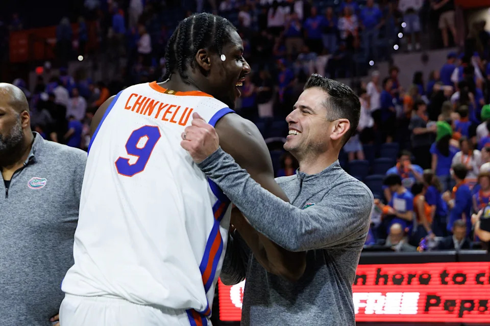 Feb 17, 2026; Gainesville, Florida, USA; Florida Gators center Rueben Chinyelu (9) and Florida Gators head coach Todd Golden smile and hug after a game against the South Carolina Gamecocks at Exactech Arena at the Stephen C. O'Connell Center. Mandatory Credit: Matt Pendleton-Imagn Images