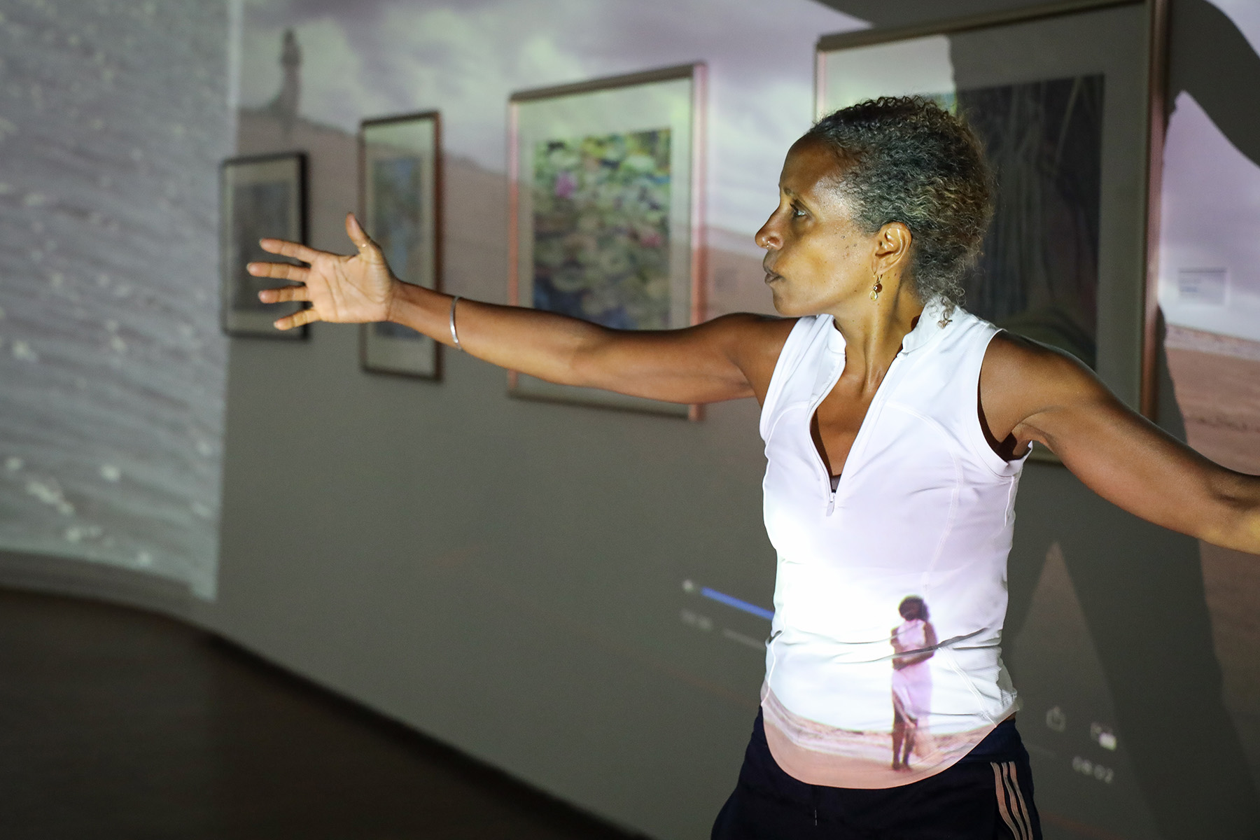 Person holding their arms open, performing an art exhibit