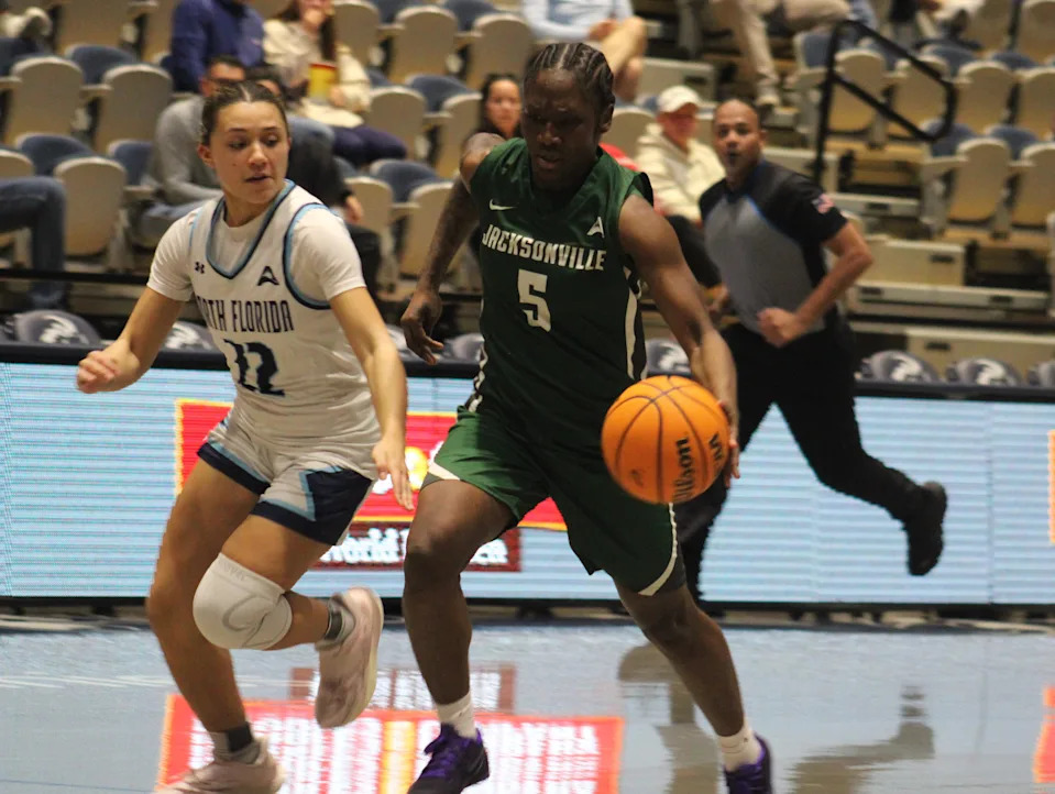 Jacksonville University guard Comari Mitchell (5) dribbles up the court against University of North Florida guard Alexa Washington (22) during a women's college basketball game on Feb. 14, 2026. [Clayton Freeman/Florida Times-Union]