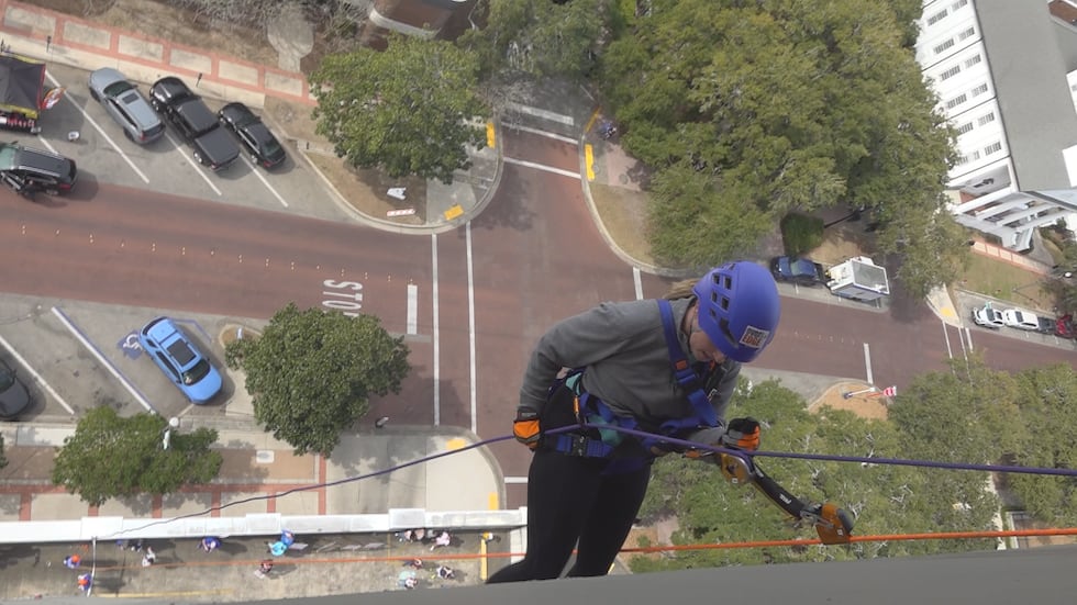 A brave rappeler begins the journey down outside the Tallahassee Double Tree during Saturday's...