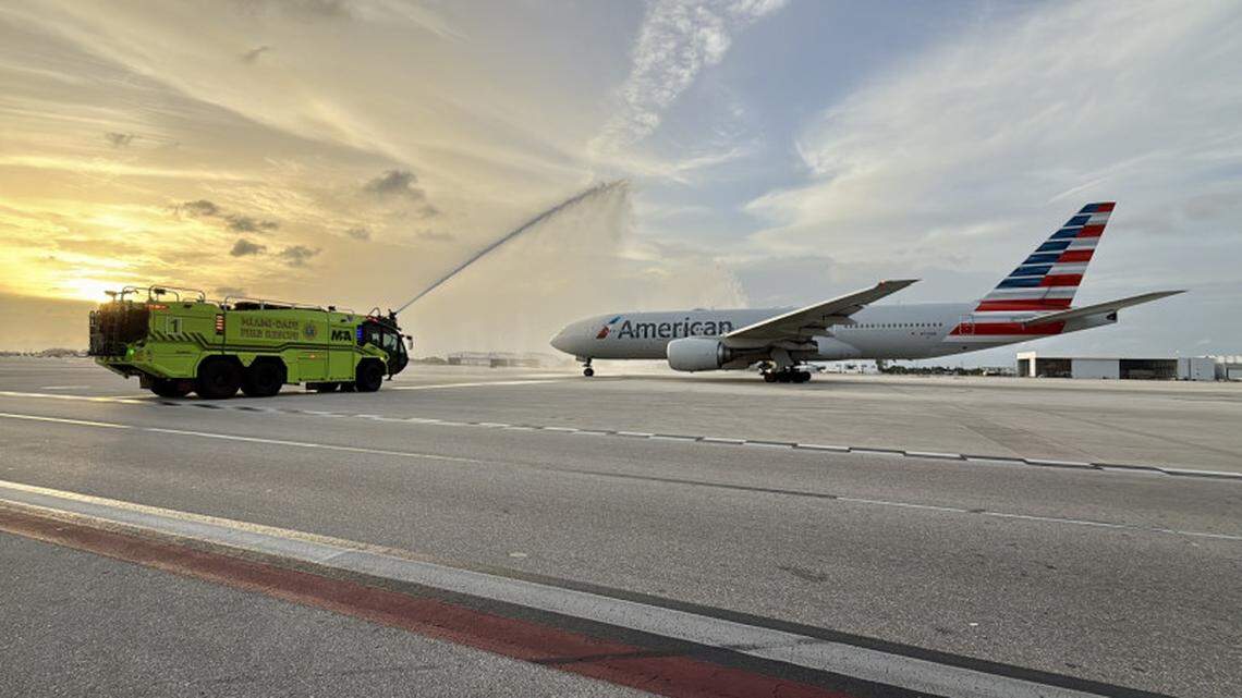 A Miami-Dade Fire Rescue truck gives a traditional water cannon salute to the inaugural Miami-Rome departure of an American Airlines plane.