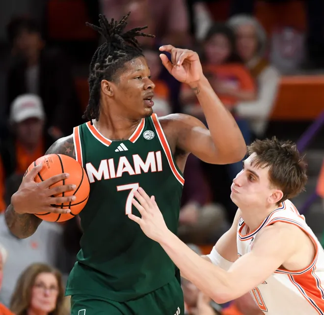 Clemson Tigers forward Jake Wahlin (10) attempts to steal the ball from Miami Hurricanes forward Shelton Henderson (7) Saturday, Jan. 17, 2026, during the NCAA men’s basketball game at Littlejohn Coliseum in Clemson, South Carolina. Clemson Tigers won 69-59.