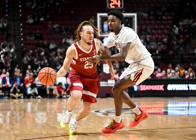 Jan 31, 2026; Tallahassee, Florida, USA; Stanford Cardinal guard Jeremy Dent-Smith (25) drives the ball to the net past Florida State Seminoles forward Chauncey Wiggins (7) during the first half at Donald L. Tucker Center. Mandatory Credit: Melina Myers-Imagn Images