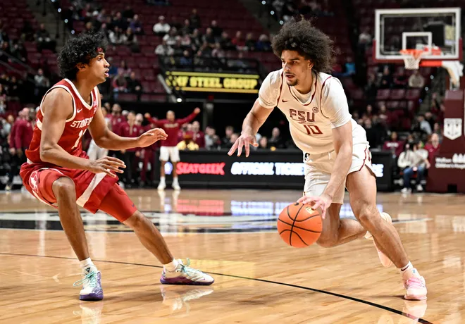 Jan 31, 2026; Tallahassee, Florida, USA; Florida State Seminoles guard Lajae Jones (10) drives the ball past Stanford Cardinal guard Ryan Agarwal (11) during the first half at Donald L. Tucker Center. Mandatory Credit: Melina Myers-Imagn Images
