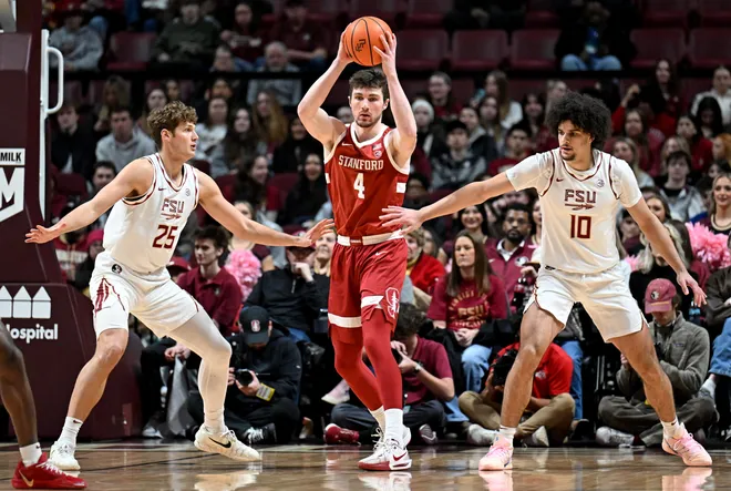 Jan 31, 2026; Tallahassee, Florida, USA; Stanford Cardinal forward AJ Rohosy (4) looks to pass the ball as he is defended by Florida State Seminoles forward Alex Steen (25) and guard Lajae Jones (10) during the first half at Donald L. Tucker Center. Mandatory Credit: Melina Myers-Imagn Images