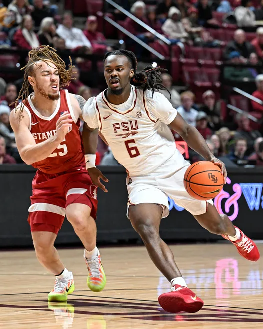 Jan 31, 2026; Tallahassee, Florida, USA; Florida State Seminoles guard Robert McCray (6) drives to the net past Stanford Cardinal guard Jeremy Dent-Smith (25) during the first half at Donald L. Tucker Center. Mandatory Credit: Melina Myers-Imagn Images