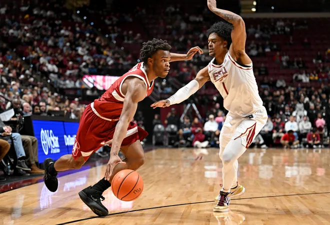 Jan 31, 2026; Tallahassee, Florida, USA; Stanford Cardinal guard Ebuka Okorie (1) drives to the net as Florida State Seminoles guard Martin Somerville (1) defends during the first half at Donald L. Tucker Center. Mandatory Credit: Melina Myers-Imagn Images